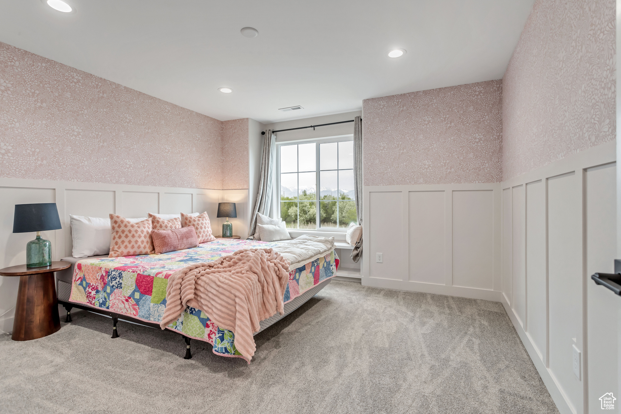 Upstairs bedroom featuring light colored carpet with window seat