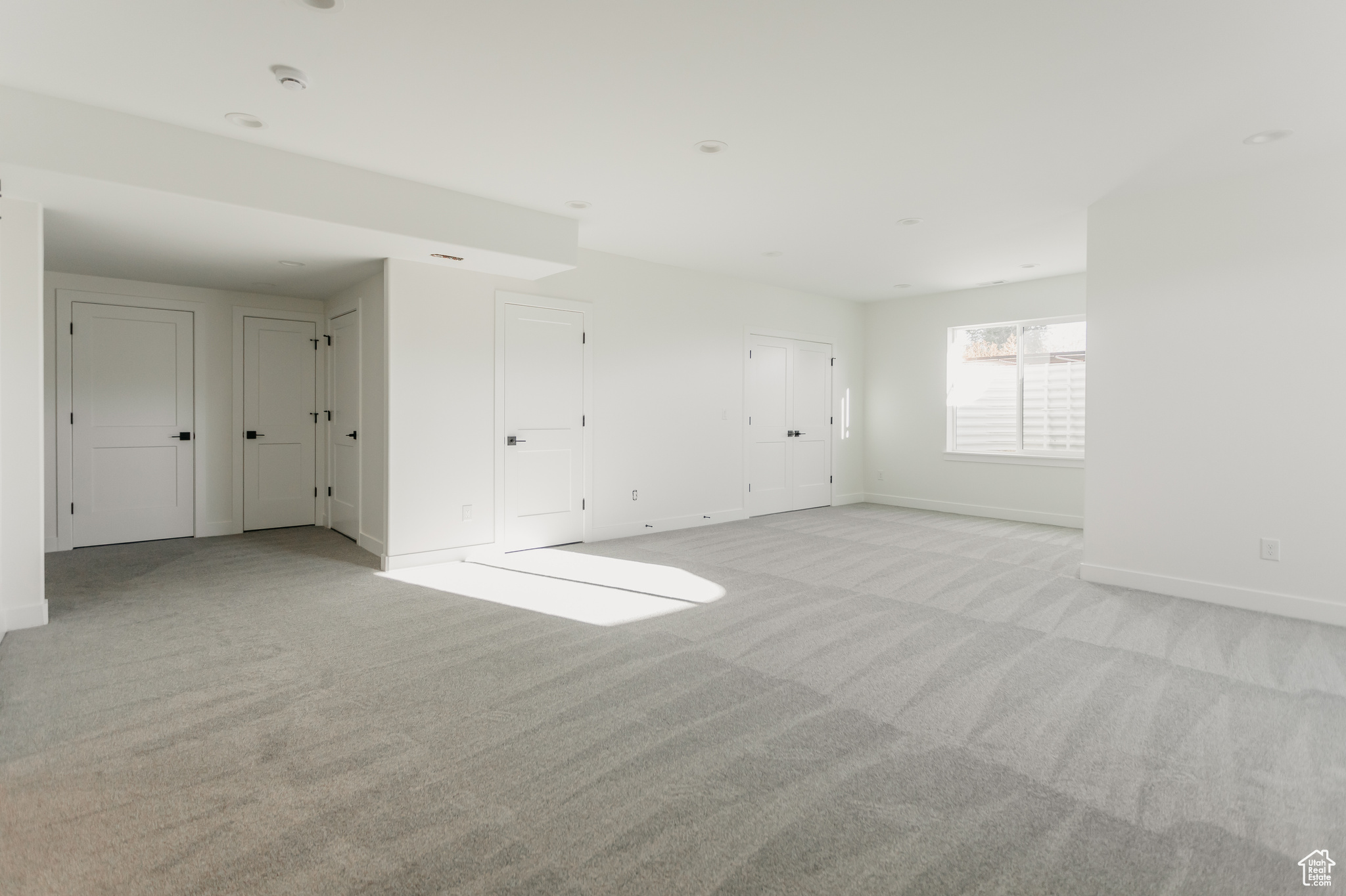 Basement rec room featuring light colored carpet and 9' ceilings throughout