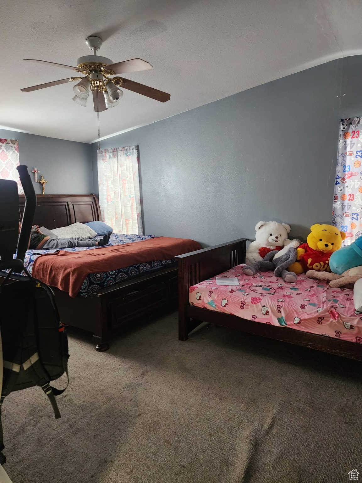 Bedroom featuring ceiling fan and carpet floors