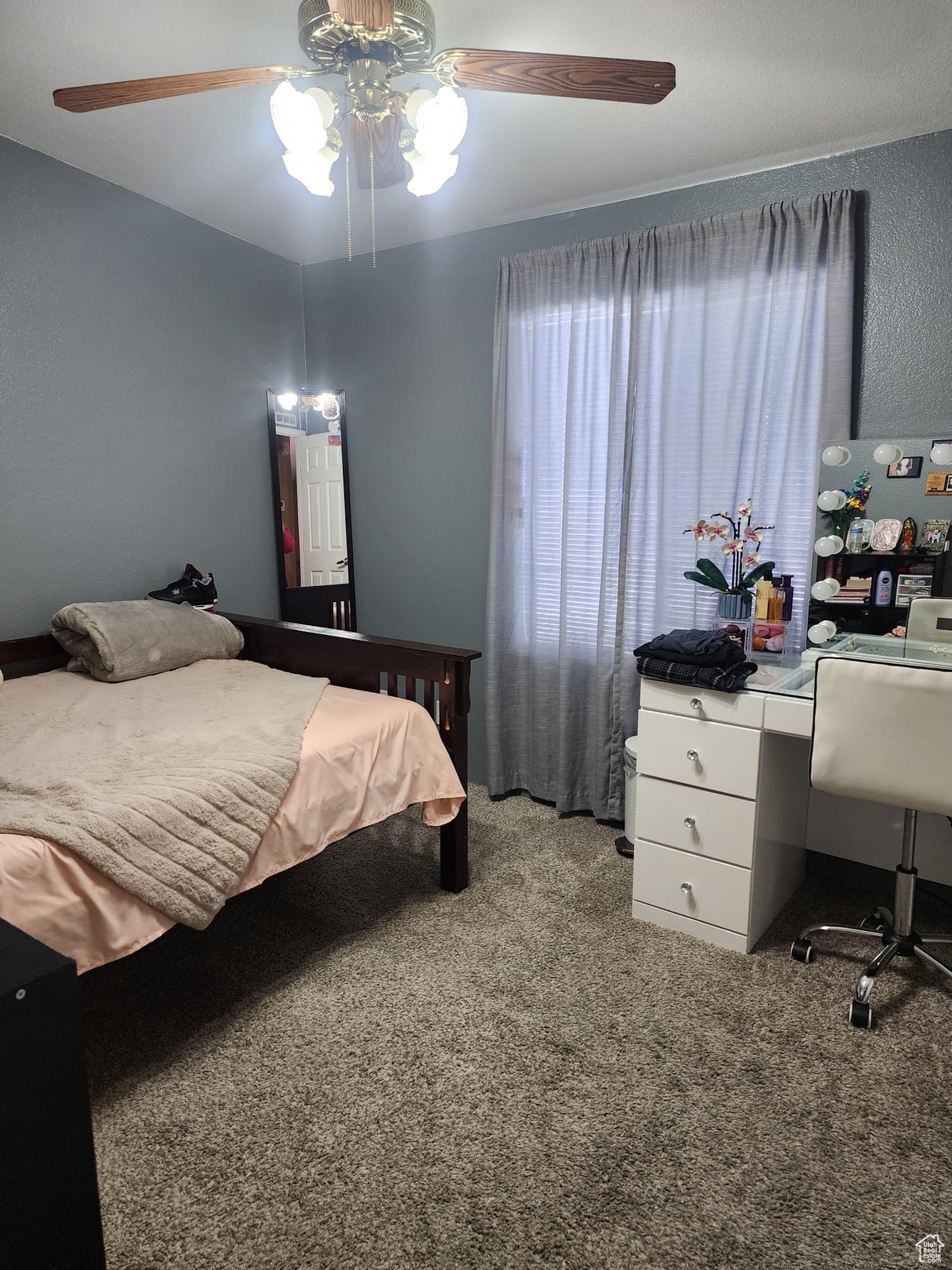 Bedroom with carpet and ceiling fan