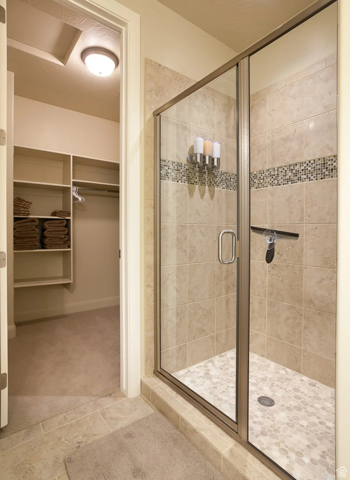 Bathroom featuring walk in shower and tile floors