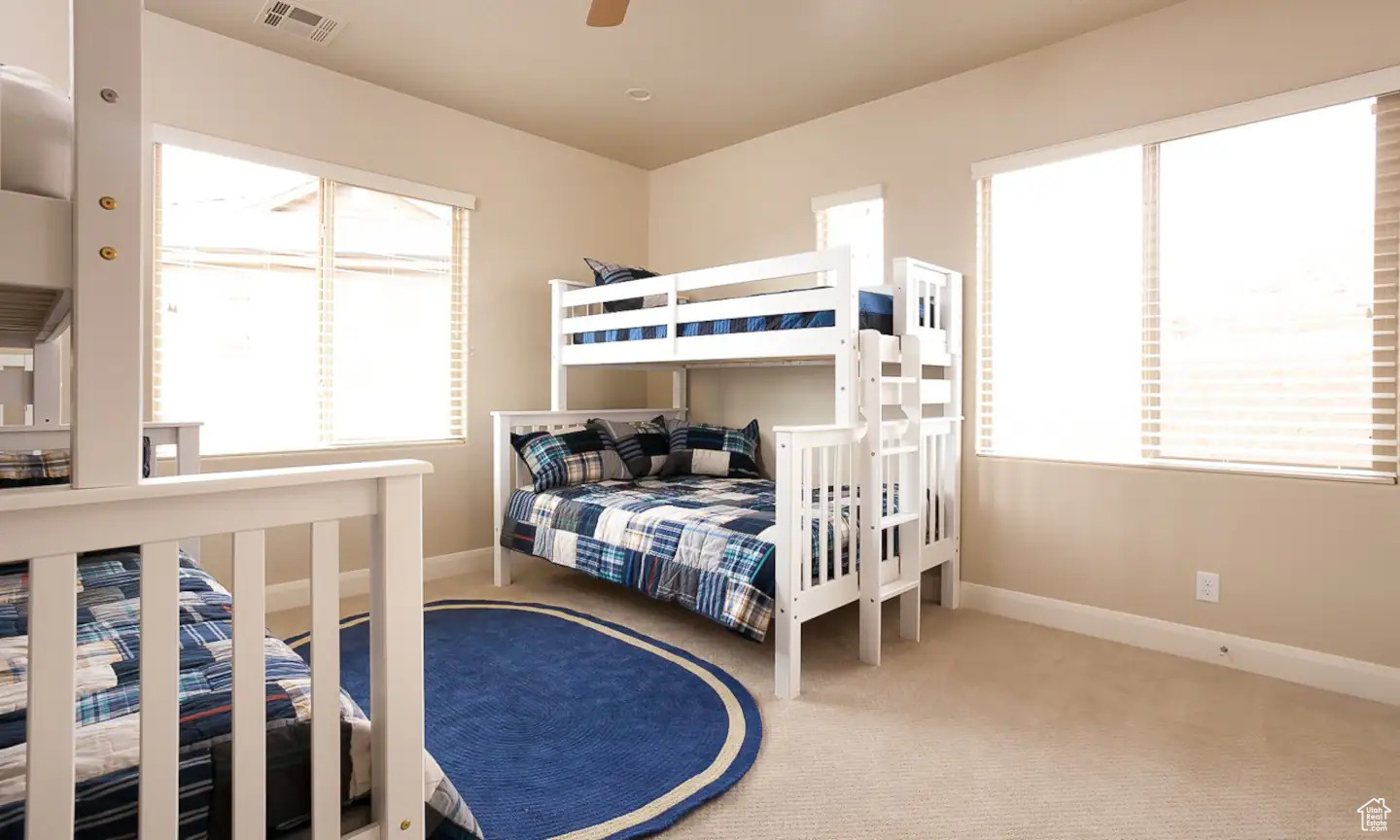 Bedroom with ceiling fan and carpet flooring