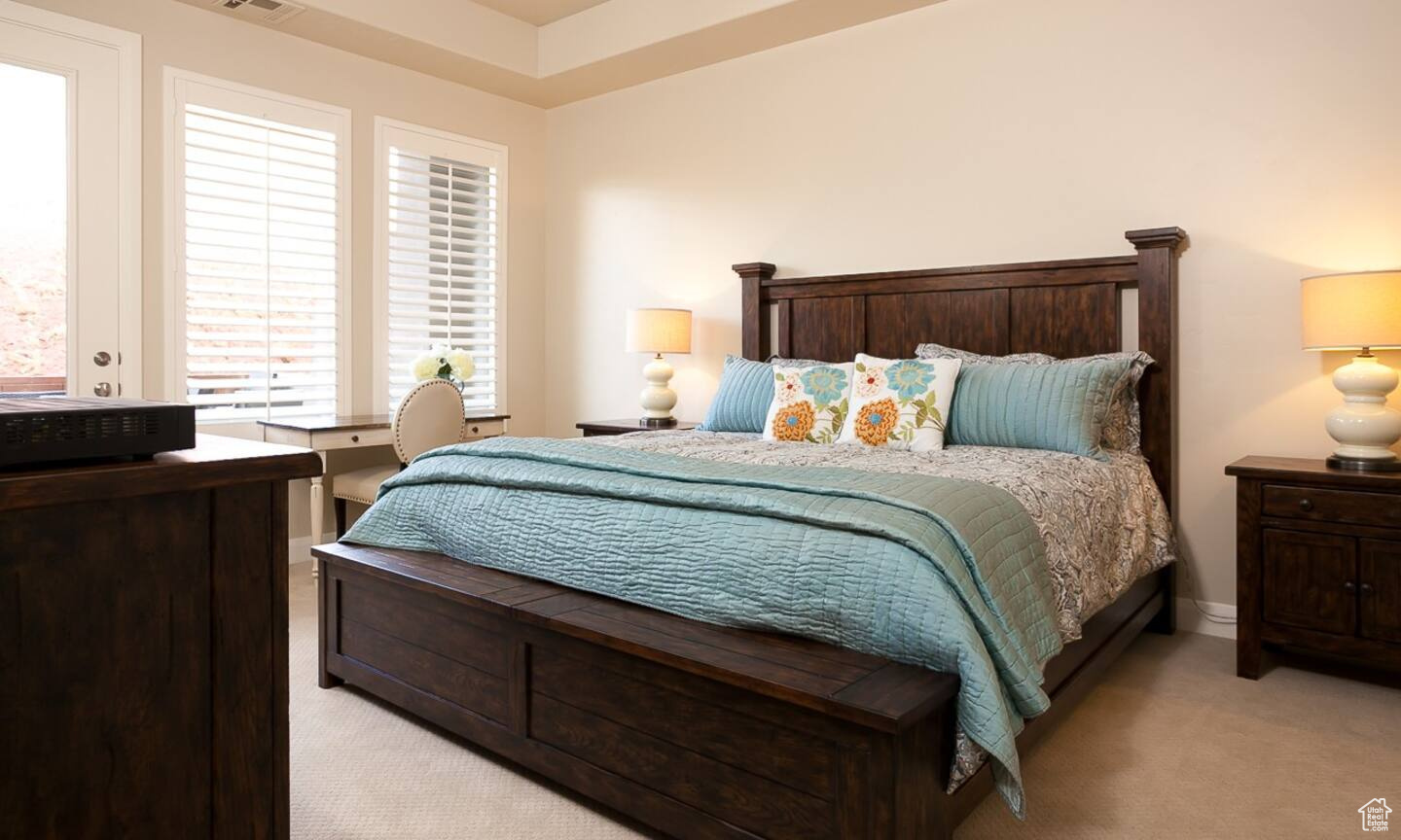 Bedroom with light colored carpet