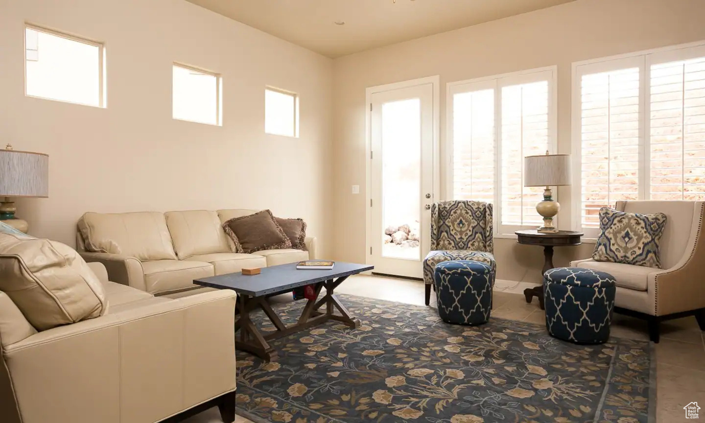 Tiled living room featuring a wealth of natural light