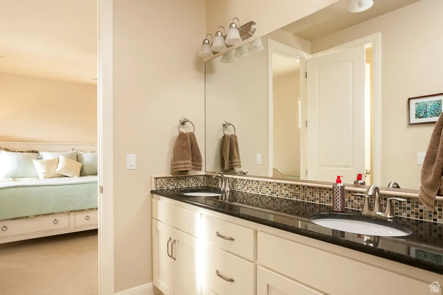 Bathroom featuring double sink, tasteful backsplash, and large vanity