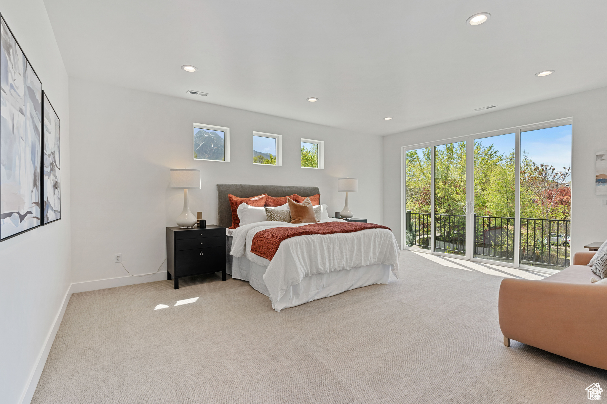 Primary Bedroom with light colored carpet and access to outside