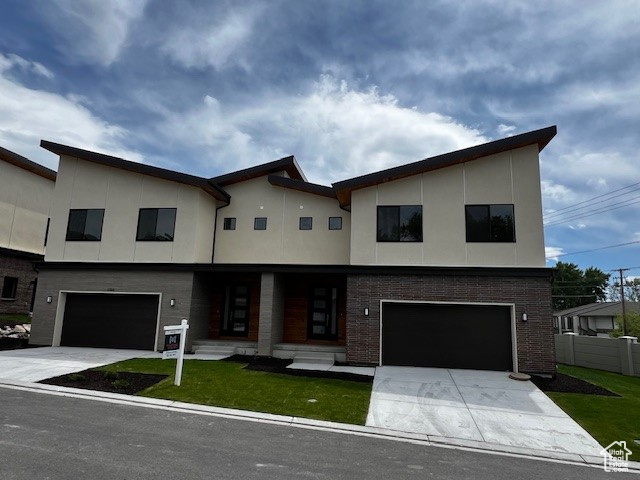 Modern home featuring a garage and a front yard