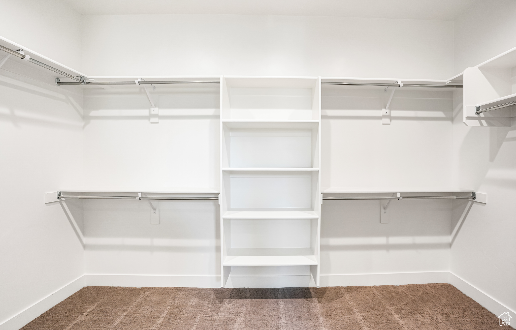 Primary bedroom Walk in closet with carpet floors