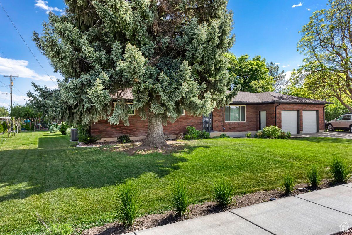 View of front of house featuring a garage and a front lawn