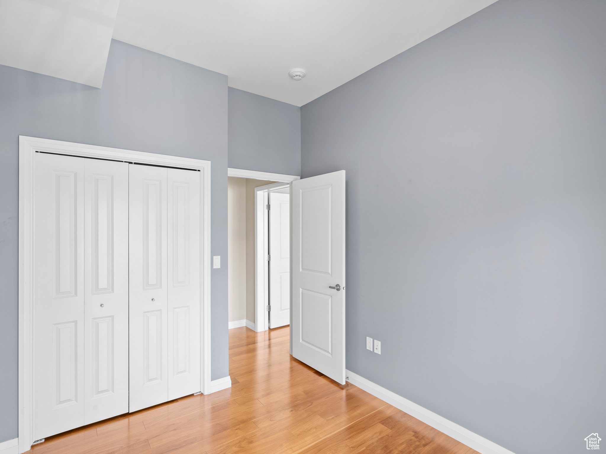 Unfurnished bedroom with a closet and light hardwood / wood-style floors