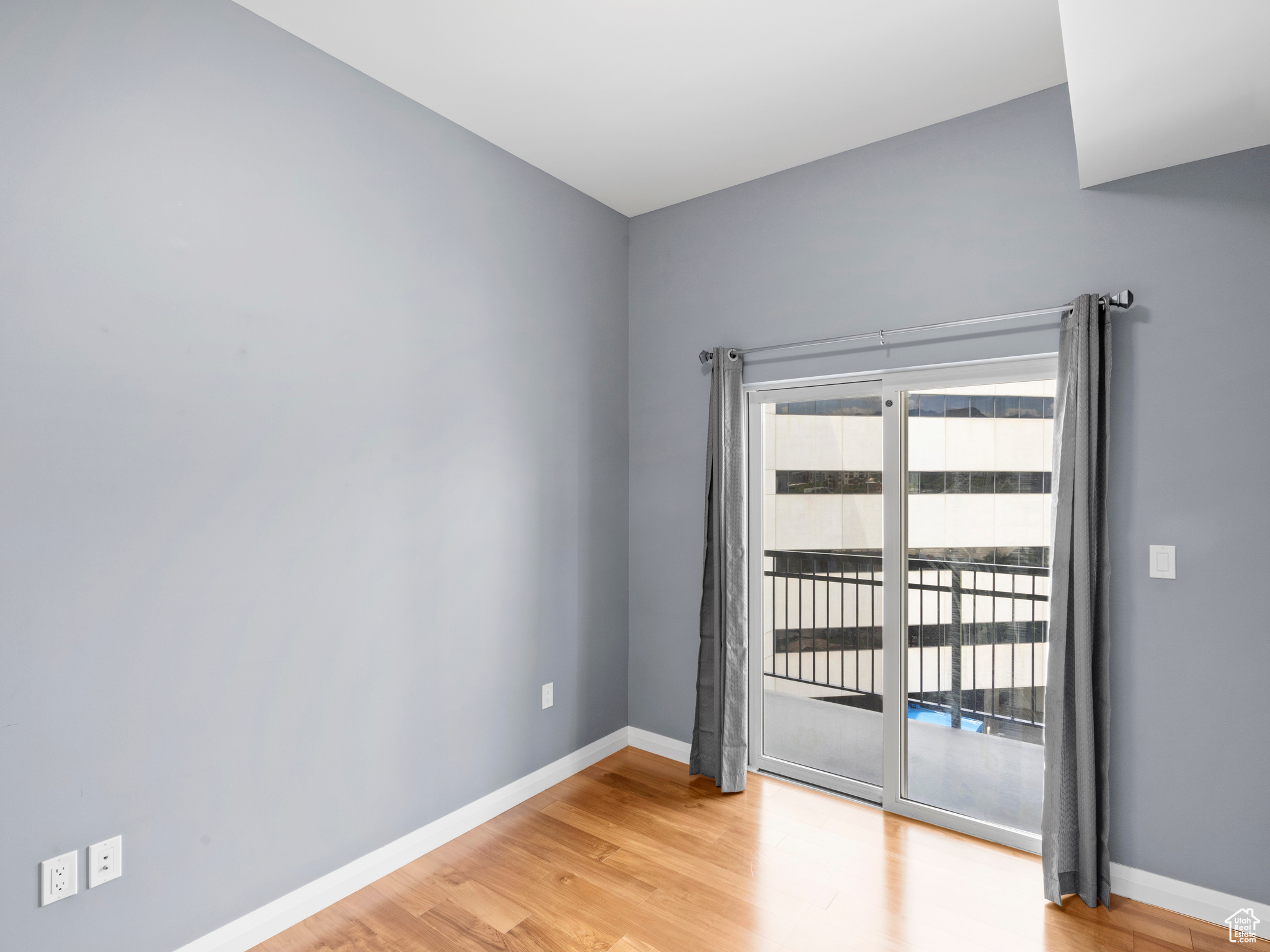 Empty room featuring a wealth of natural light and light hardwood / wood-style flooring