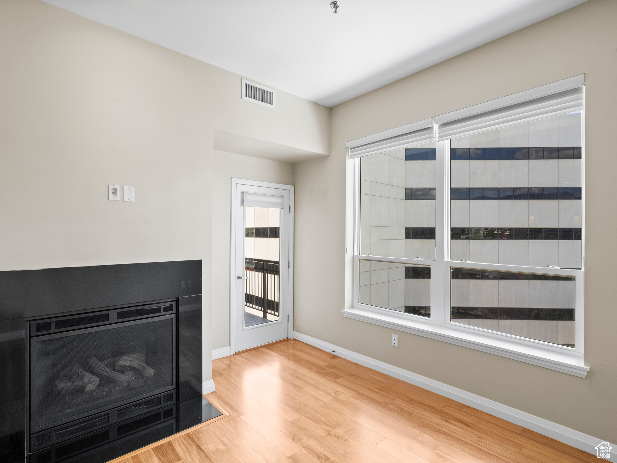 Unfurnished living room with light hardwood / wood-style floors