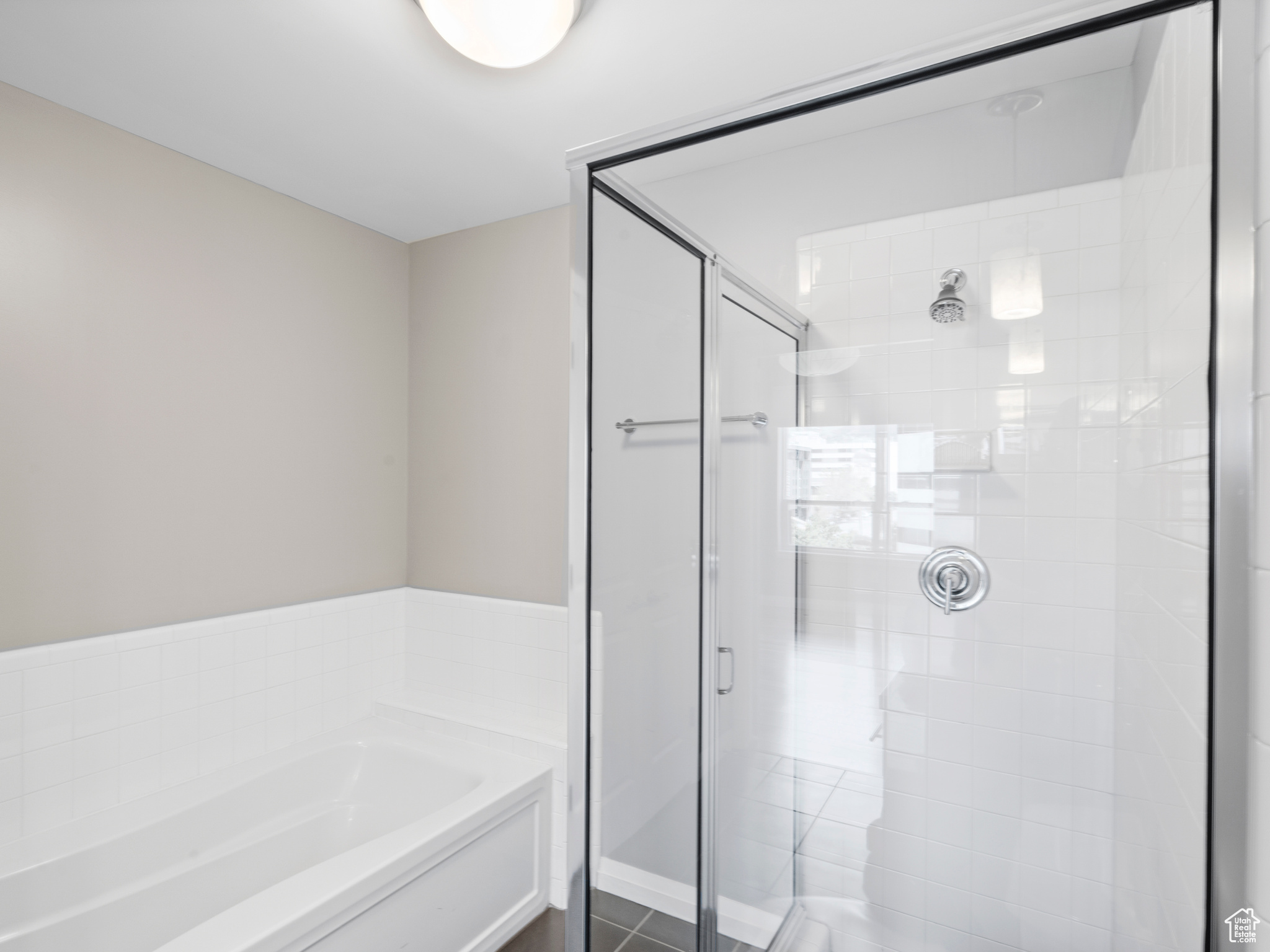 Bathroom featuring tile flooring and separate shower and tub