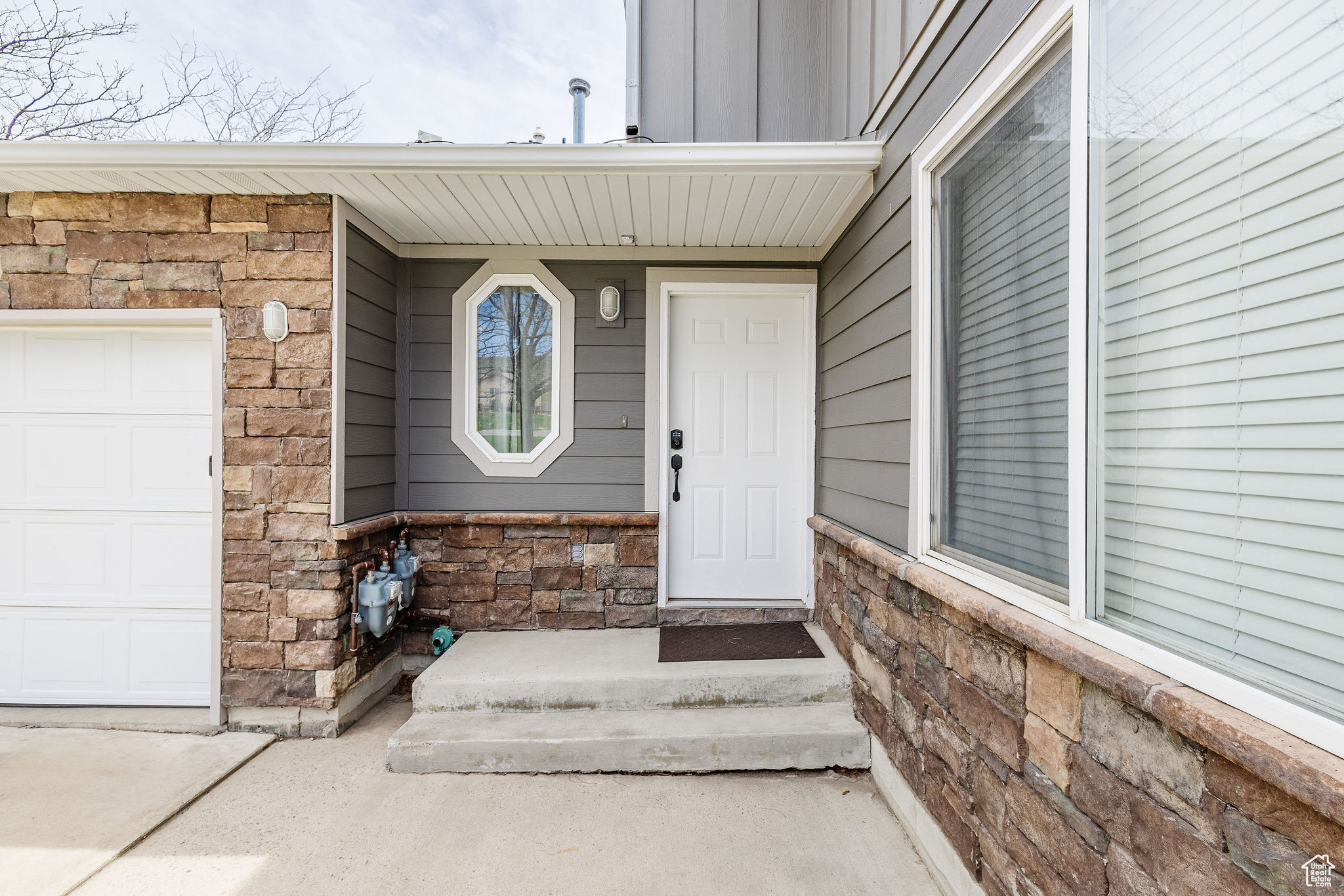 Doorway to property with a garage