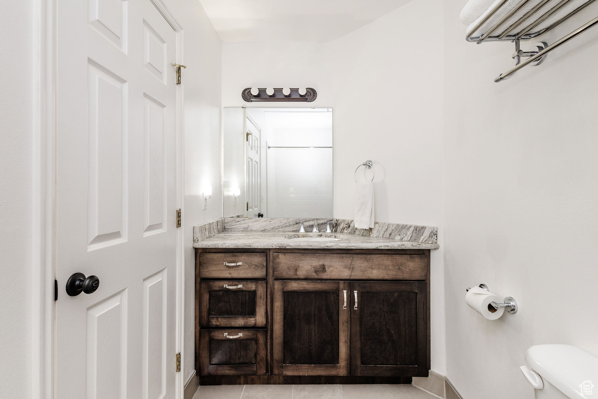 Bathroom featuring tile floors, toilet, and oversized vanity