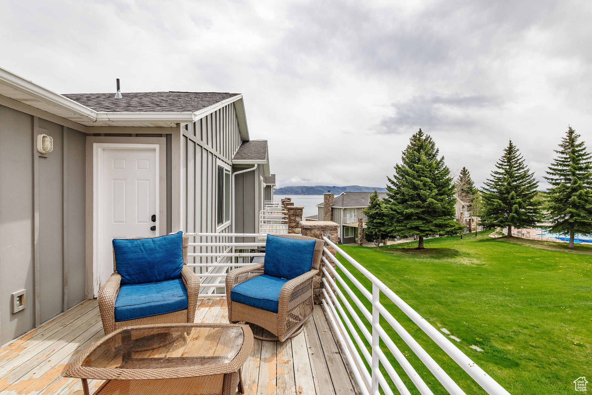 Wooden terrace with a lawn and a water view