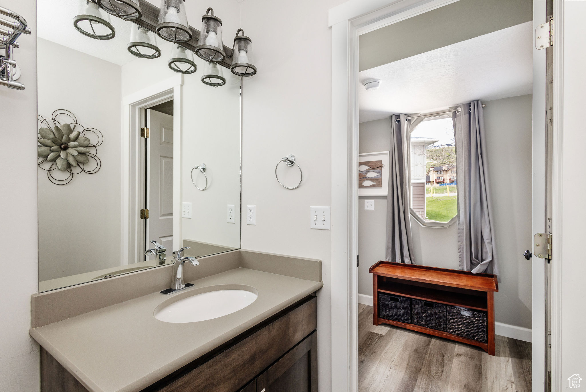 Bathroom featuring large vanity and hardwood / wood-style floors