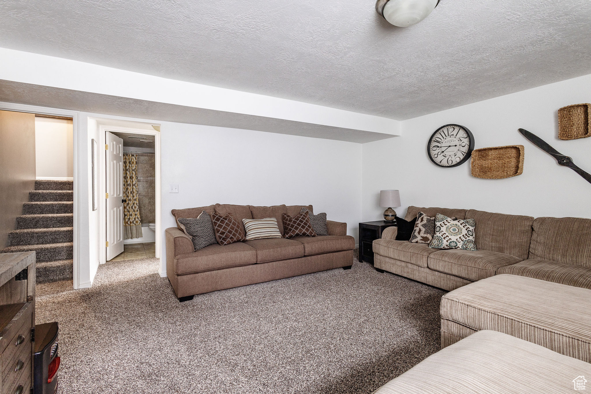 Carpeted living room featuring a textured ceiling