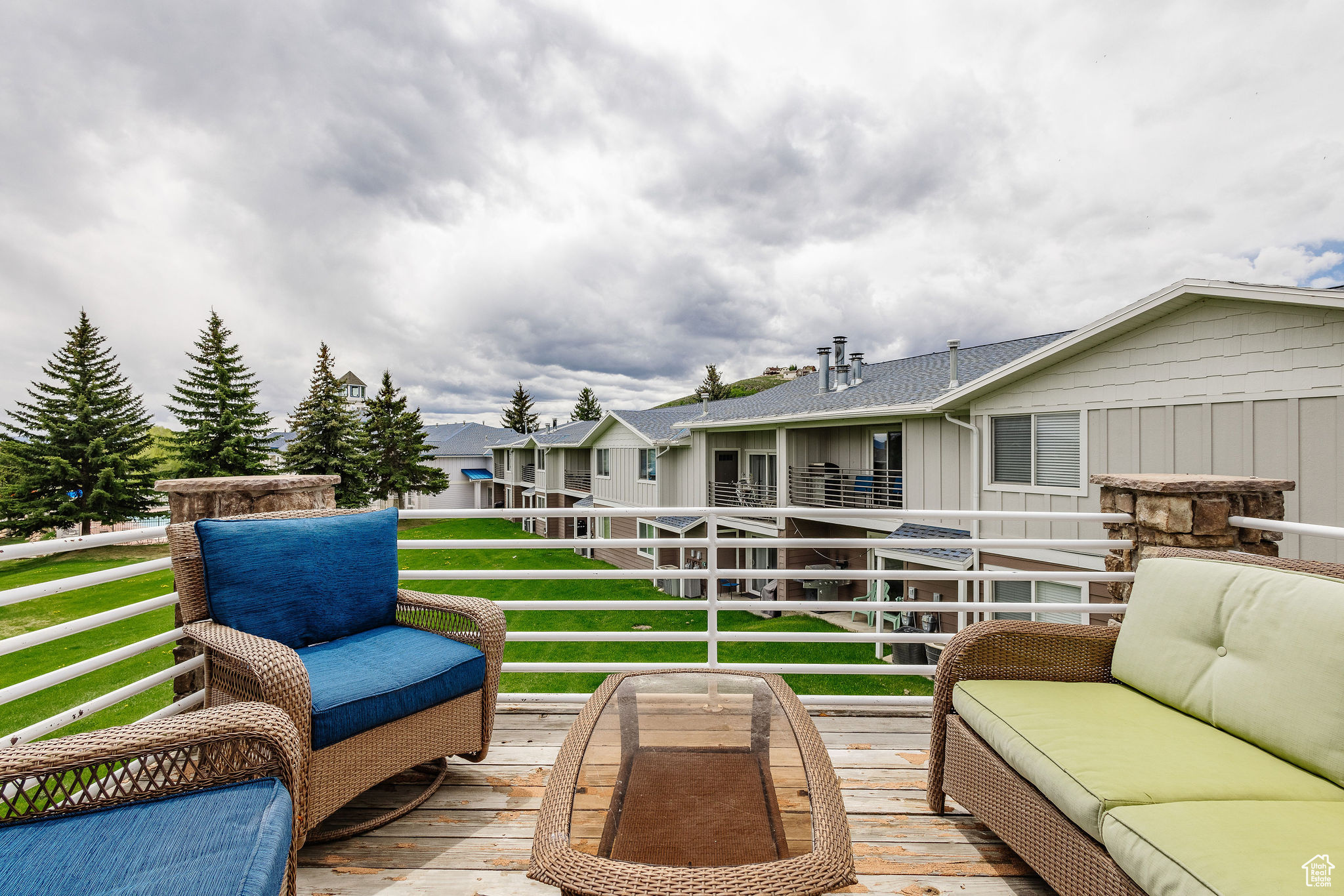 Wooden deck with a lawn and an outdoor hangout area