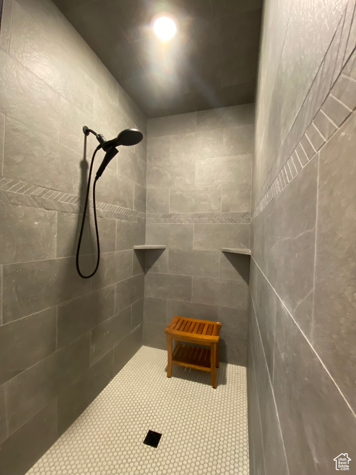 Bathroom featuring a tile shower