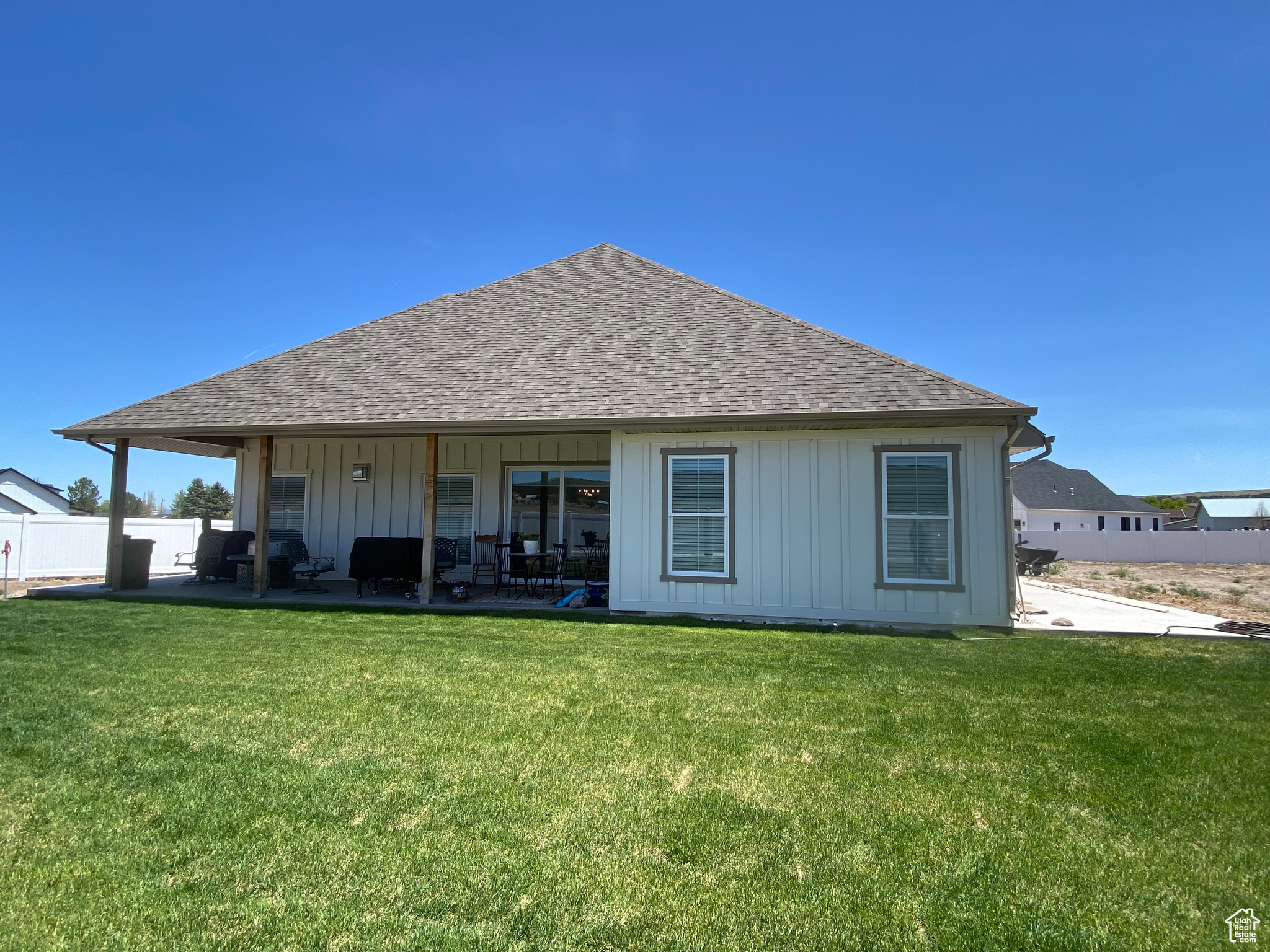 Rear view of house with a patio area and a yard