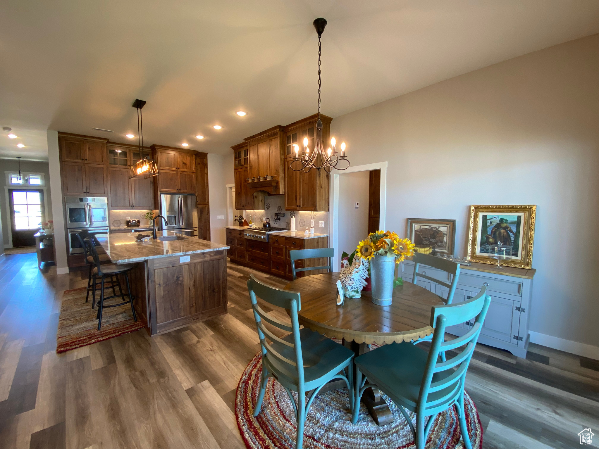 Dining room with sink, dark hardwood / wood-style flooring, and an inviting chandelier