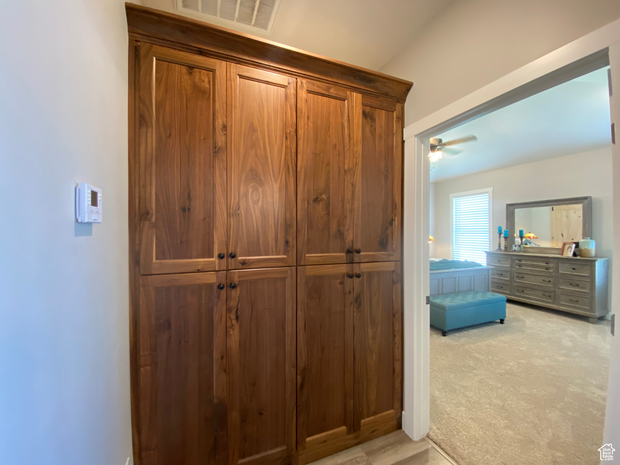 Room details with ceiling fan and carpet flooring