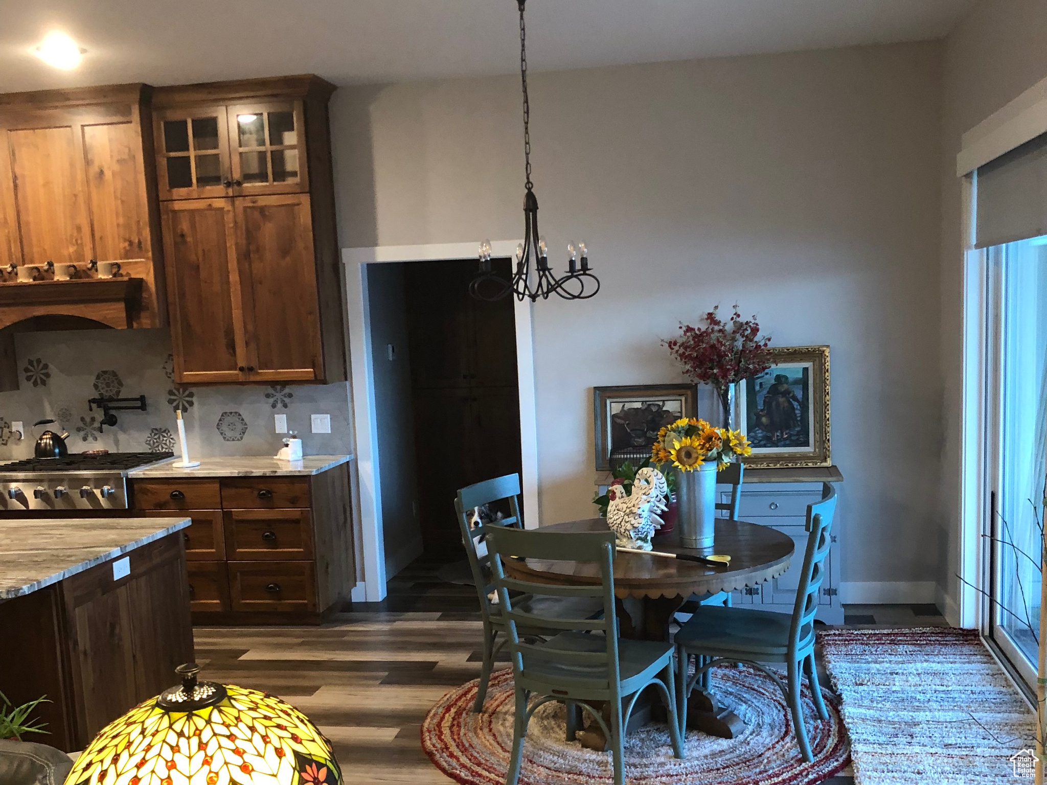 Dining area featuring a notable chandelier and hardwood / wood-style floors