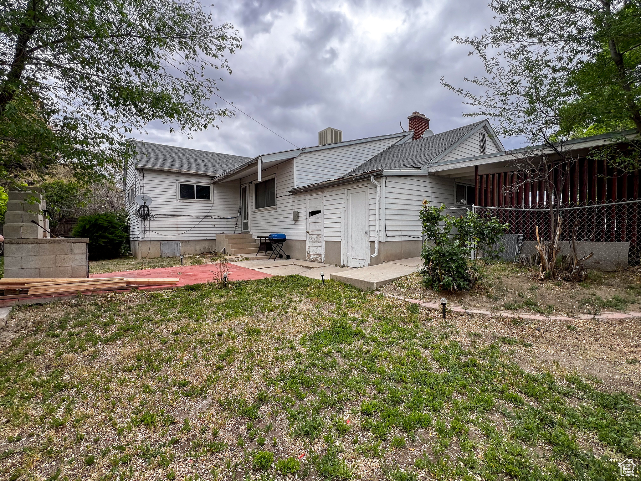 Rear view of house featuring a yard and a patio