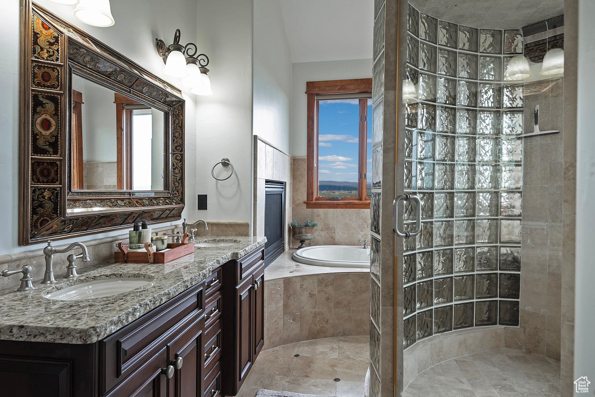 Primary Bath features an enclosed glass shower, double vanity, and independent shower and bath