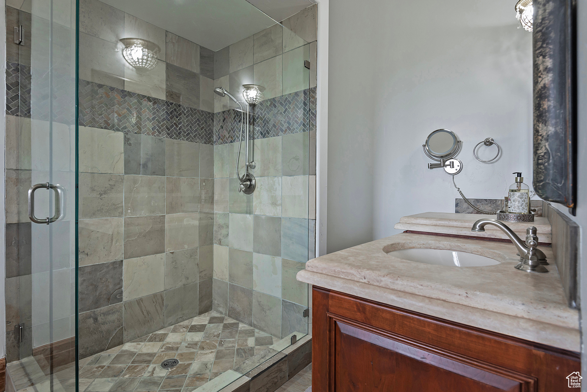 Bathroom featuring walk in shower and vanity