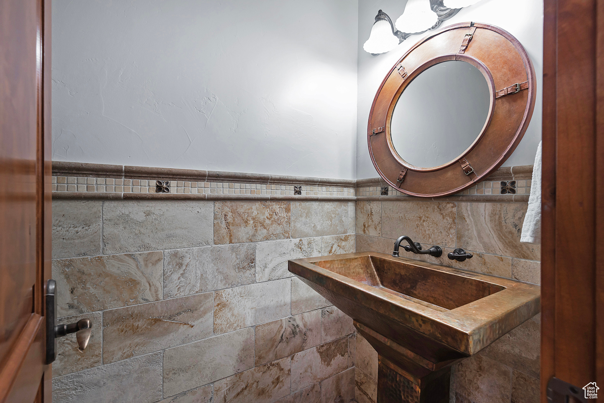 Bathroom with tile walls and tasteful backsplash