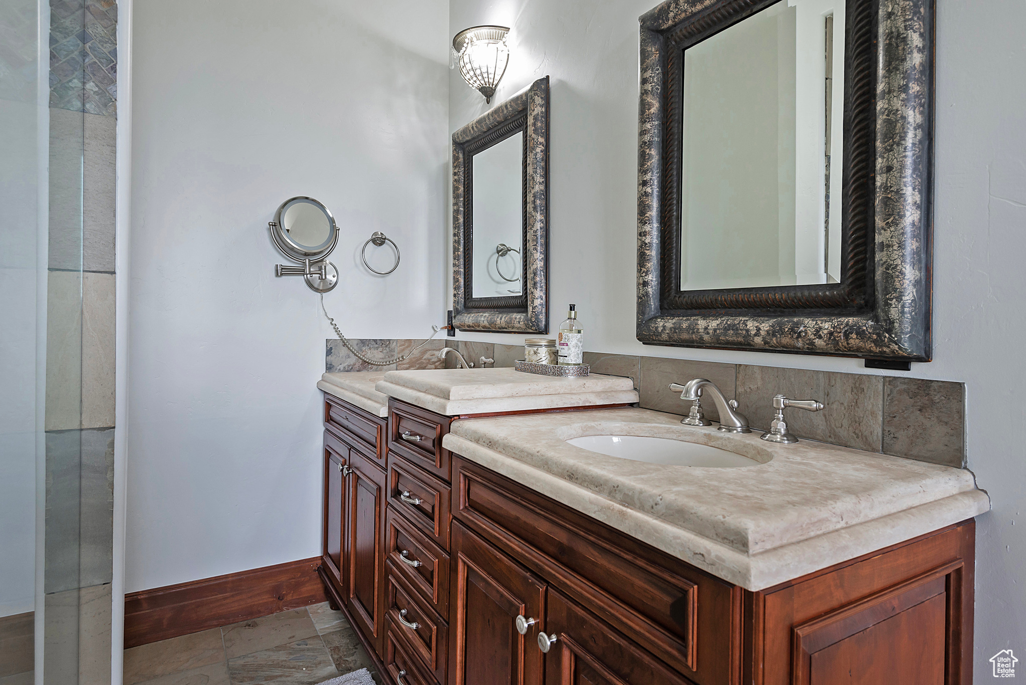 Bathroom with tile flooring and dual bowl vanity