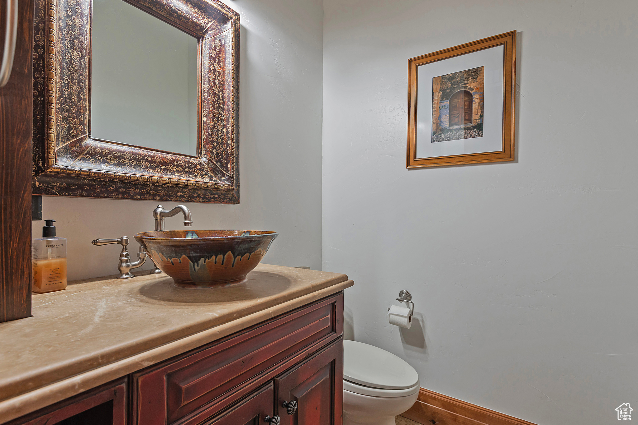 Bathroom featuring oversized vanity and toilet