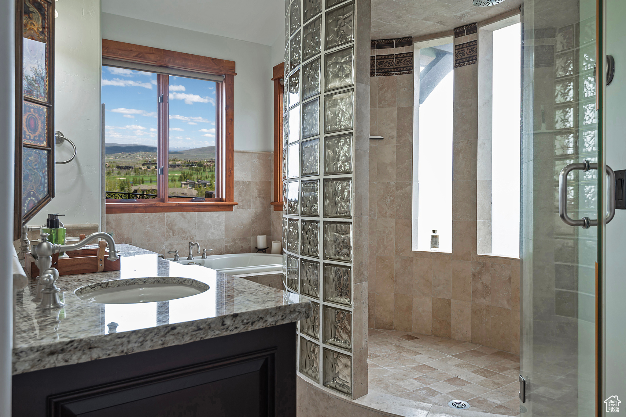 Primary Bathroom features an enclosed glass shower and double sink vanity