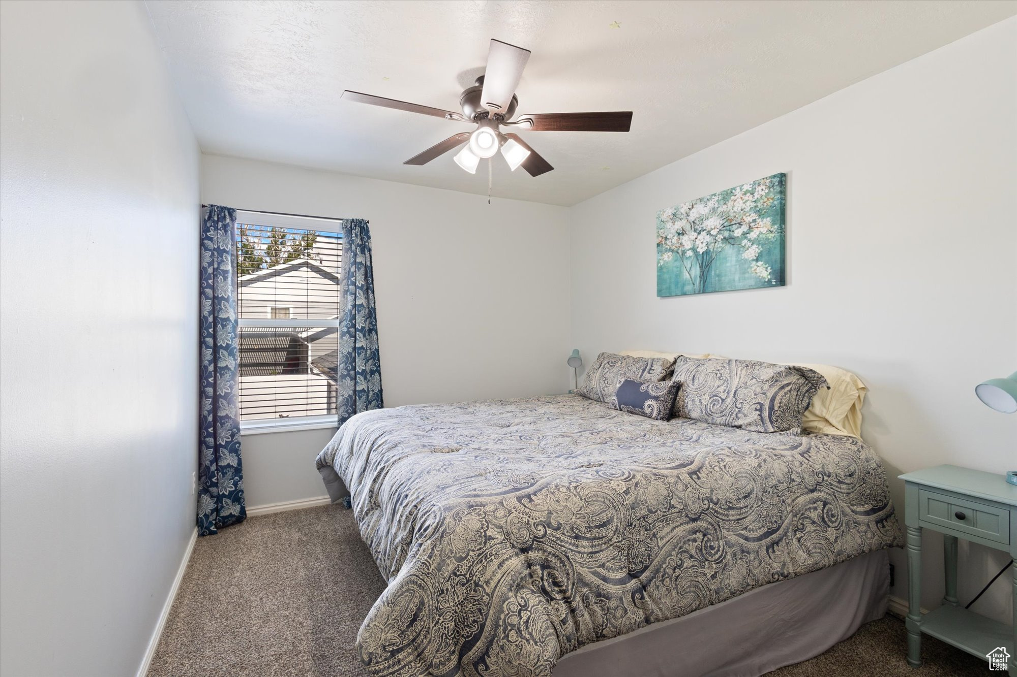 Carpeted bedroom with ceiling fan