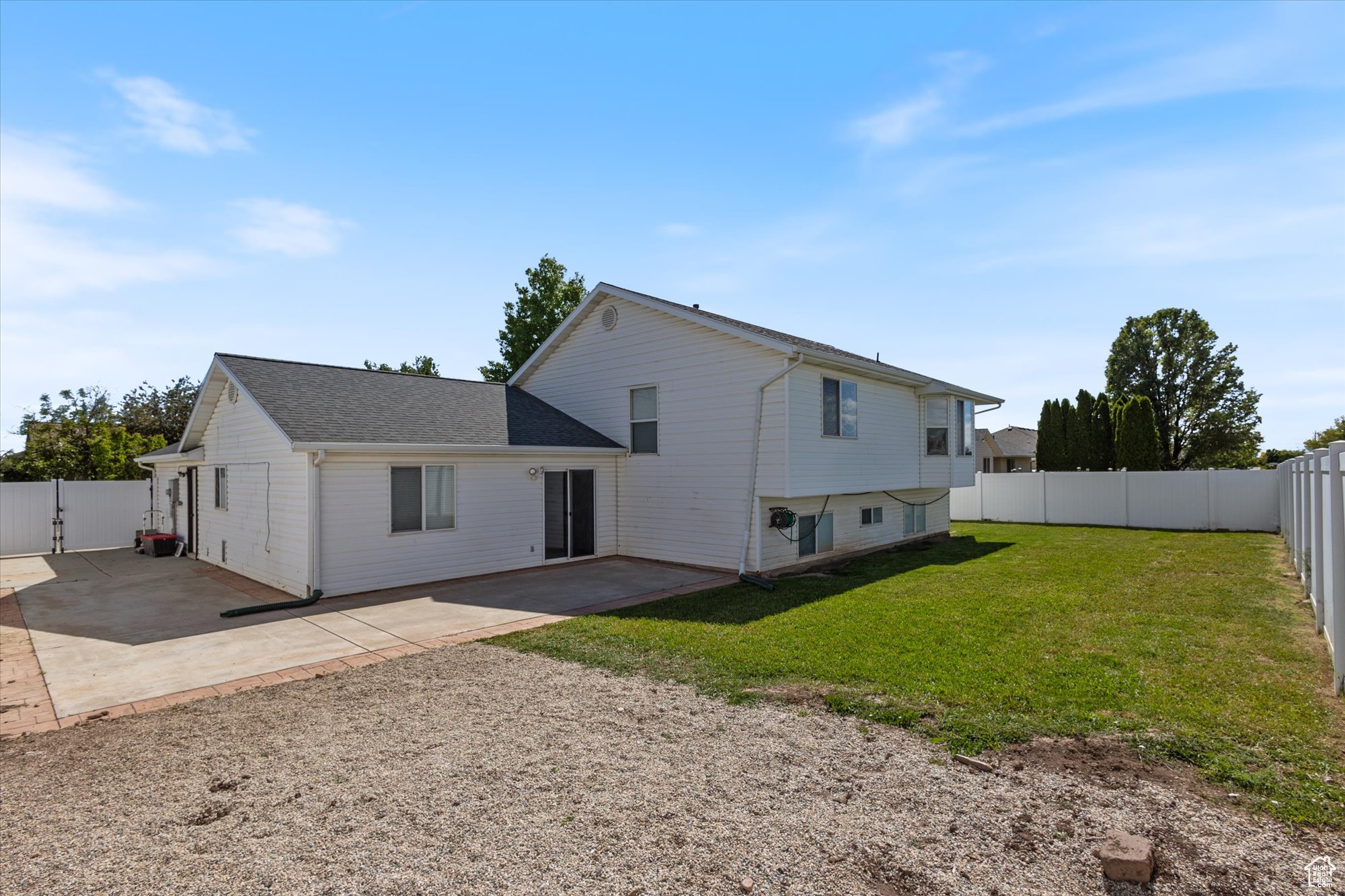 Rear view of house with a yard and a patio area