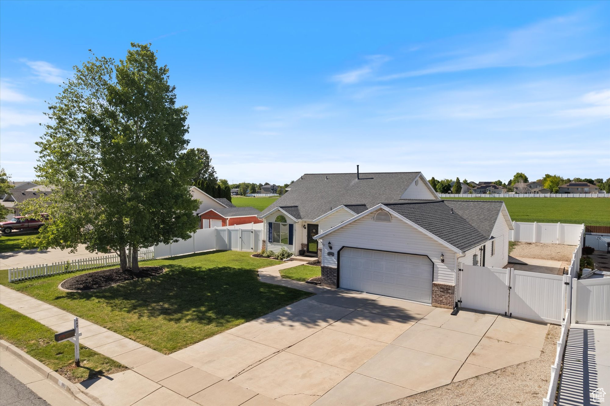 Ranch-style house featuring a 2-car garage and a front lawn