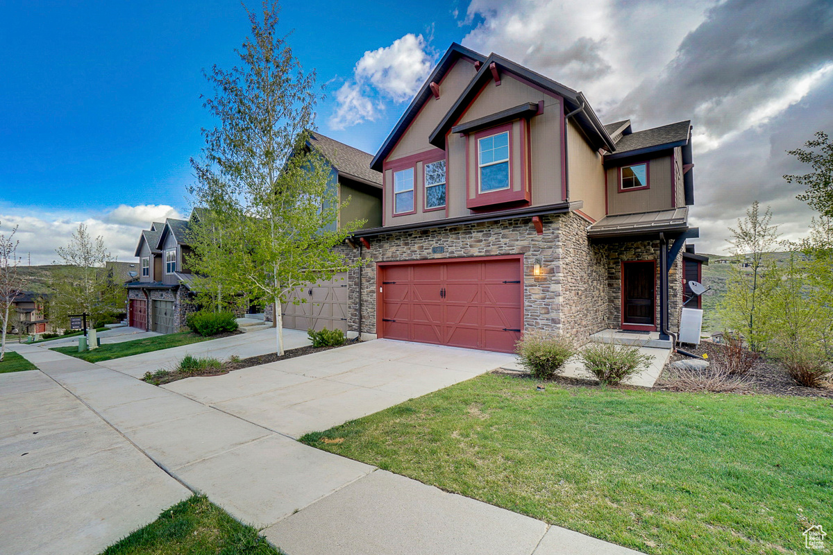 View of front of home with a front lawn and a garage