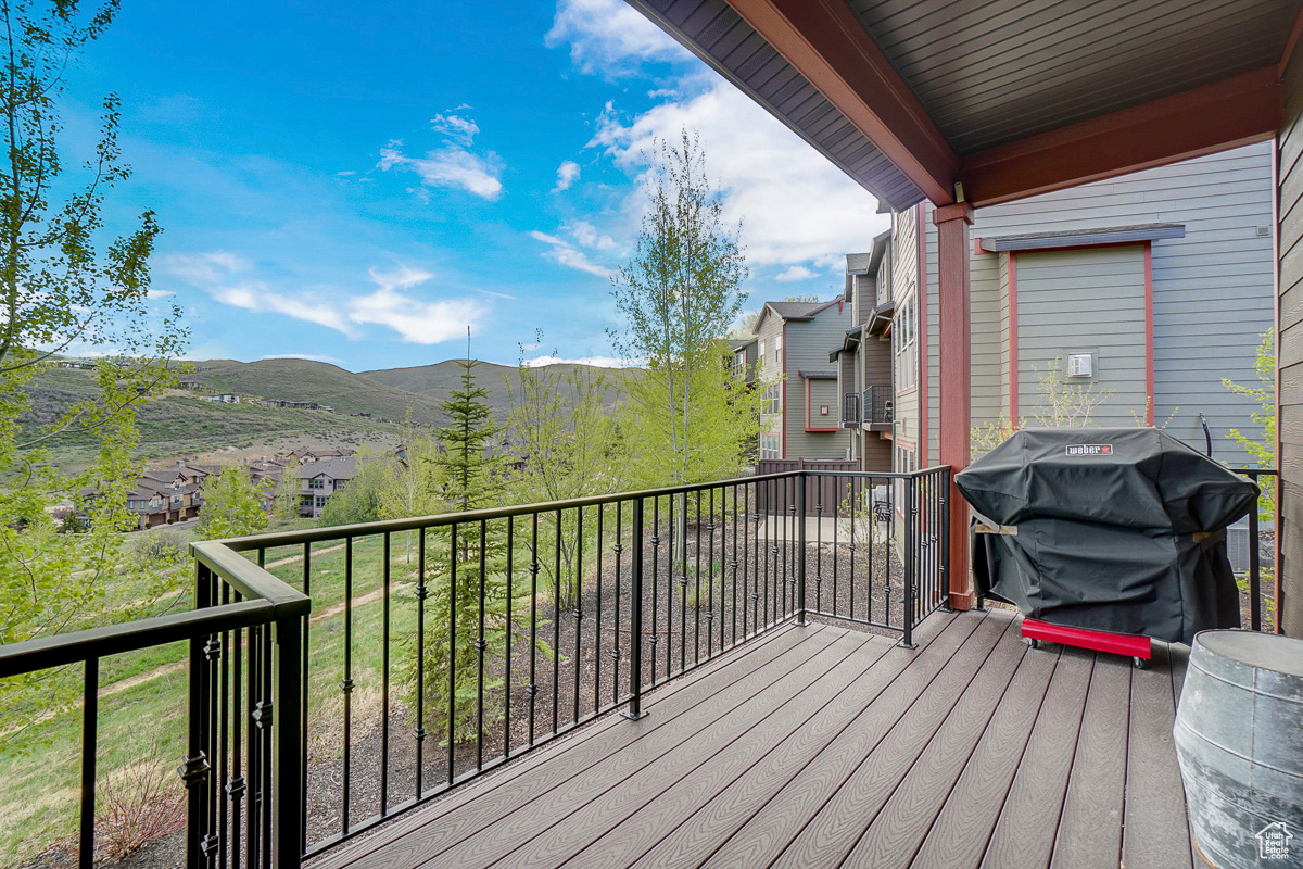 Wooden deck with a grill and a mountain view