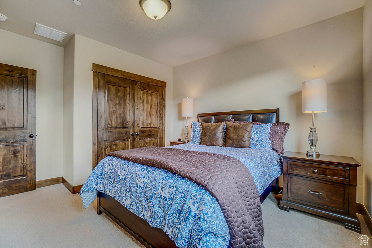 Bedroom featuring light carpet