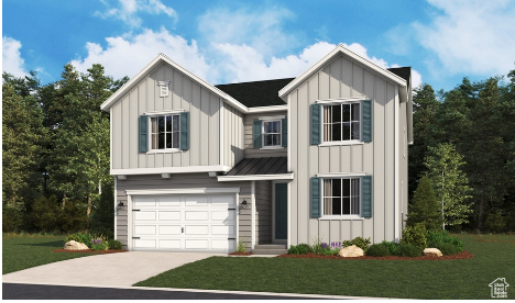 View of front of home featuring a front yard and a garage