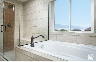 Bathroom with separate shower and tub and a mountain view