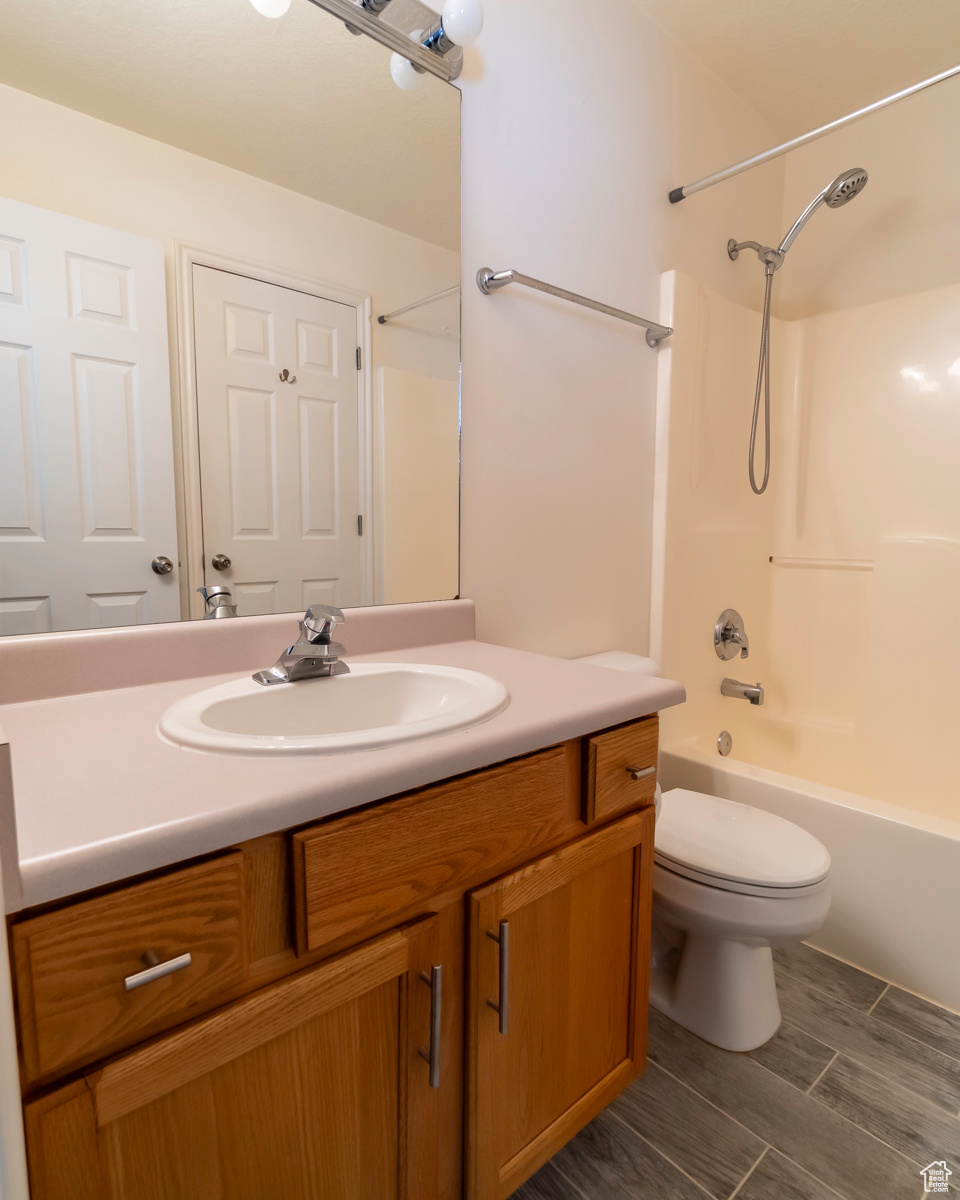 Full bathroom featuring shower / tub combination, vanity, and toilet