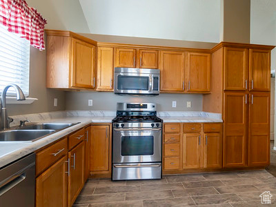 Kitchen with appliances with stainless steel finishes and sink