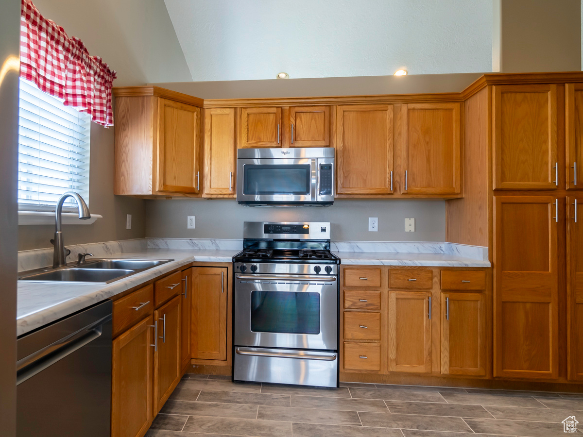 Kitchen with appliances with stainless steel finishes and sink