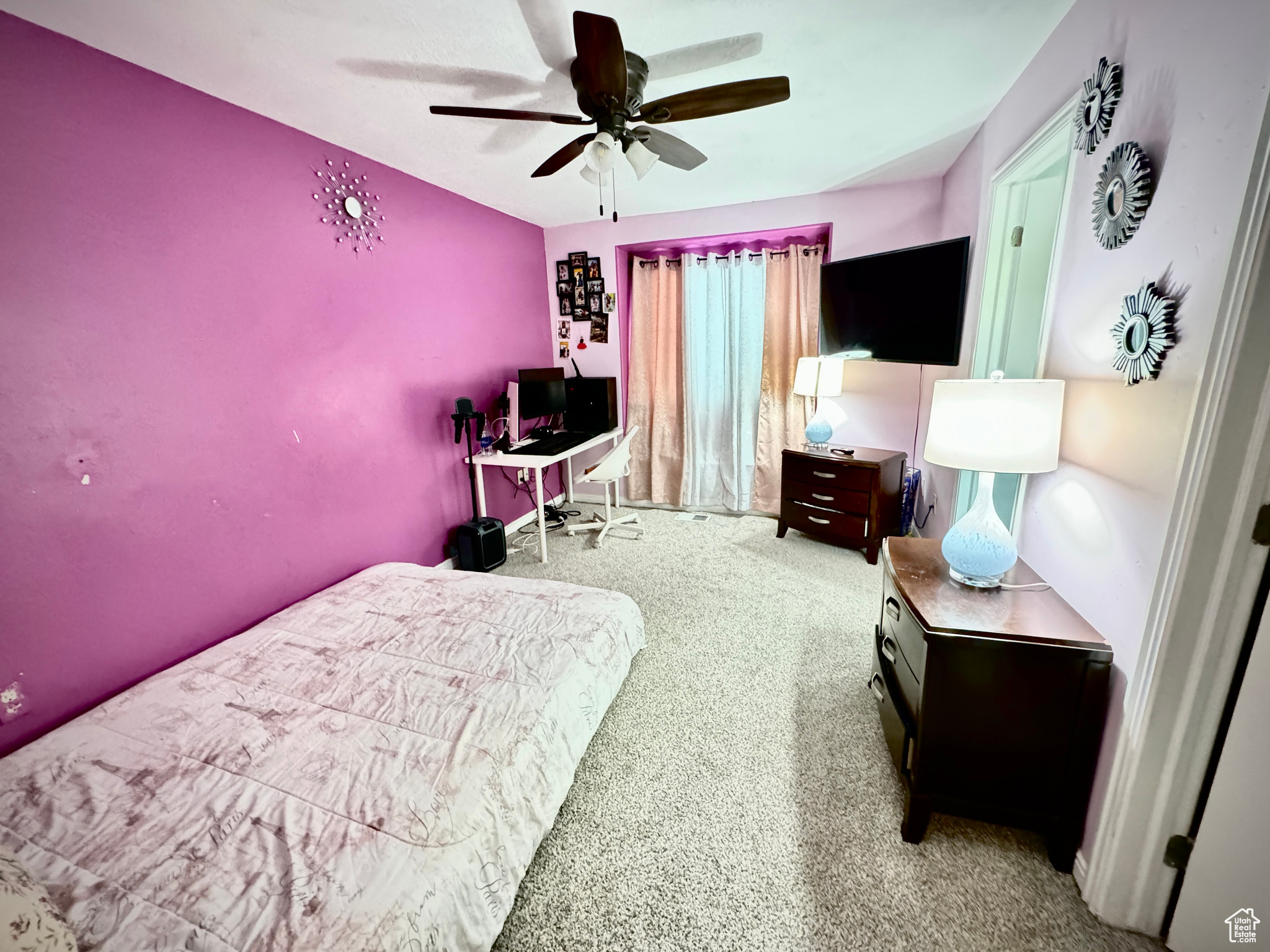 Carpeted bedroom featuring ceiling fan