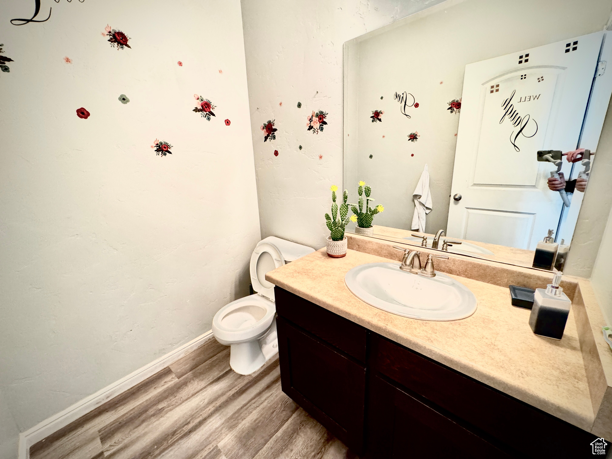 Bathroom featuring oversized vanity, hardwood / wood-style flooring, and toilet