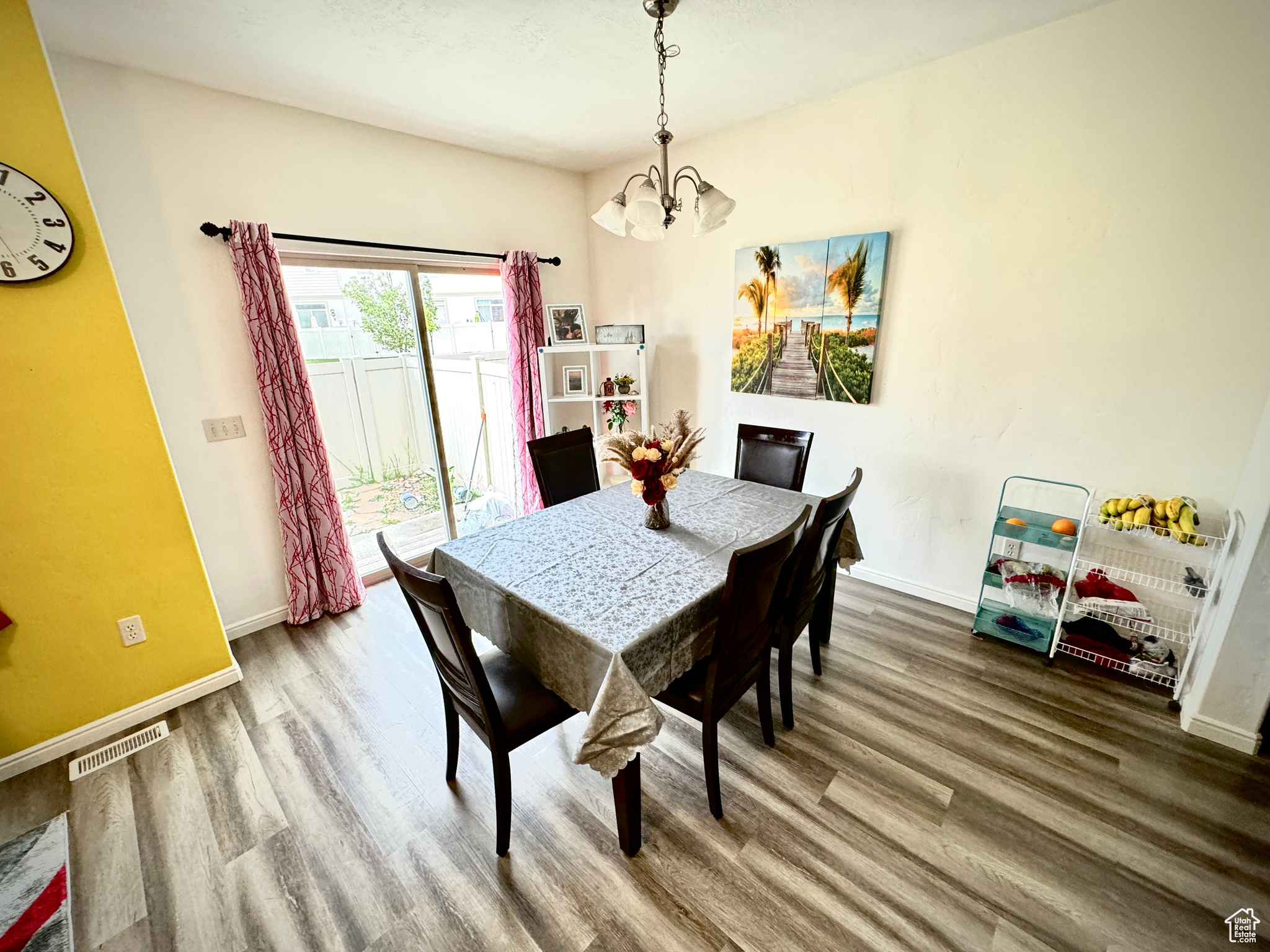 Dining space featuring an inviting chandelier and wood-type flooring