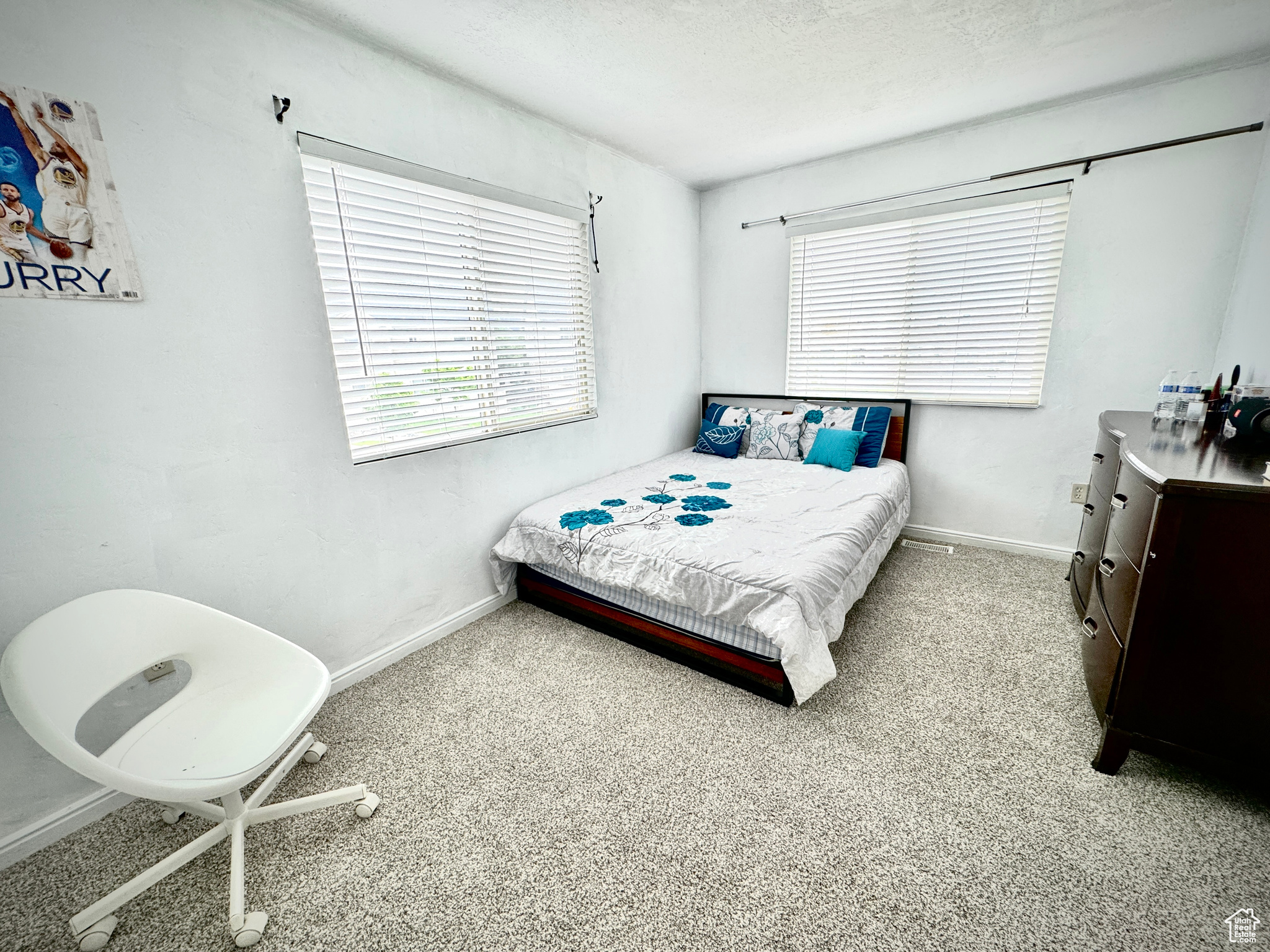 Carpeted bedroom with a textured ceiling